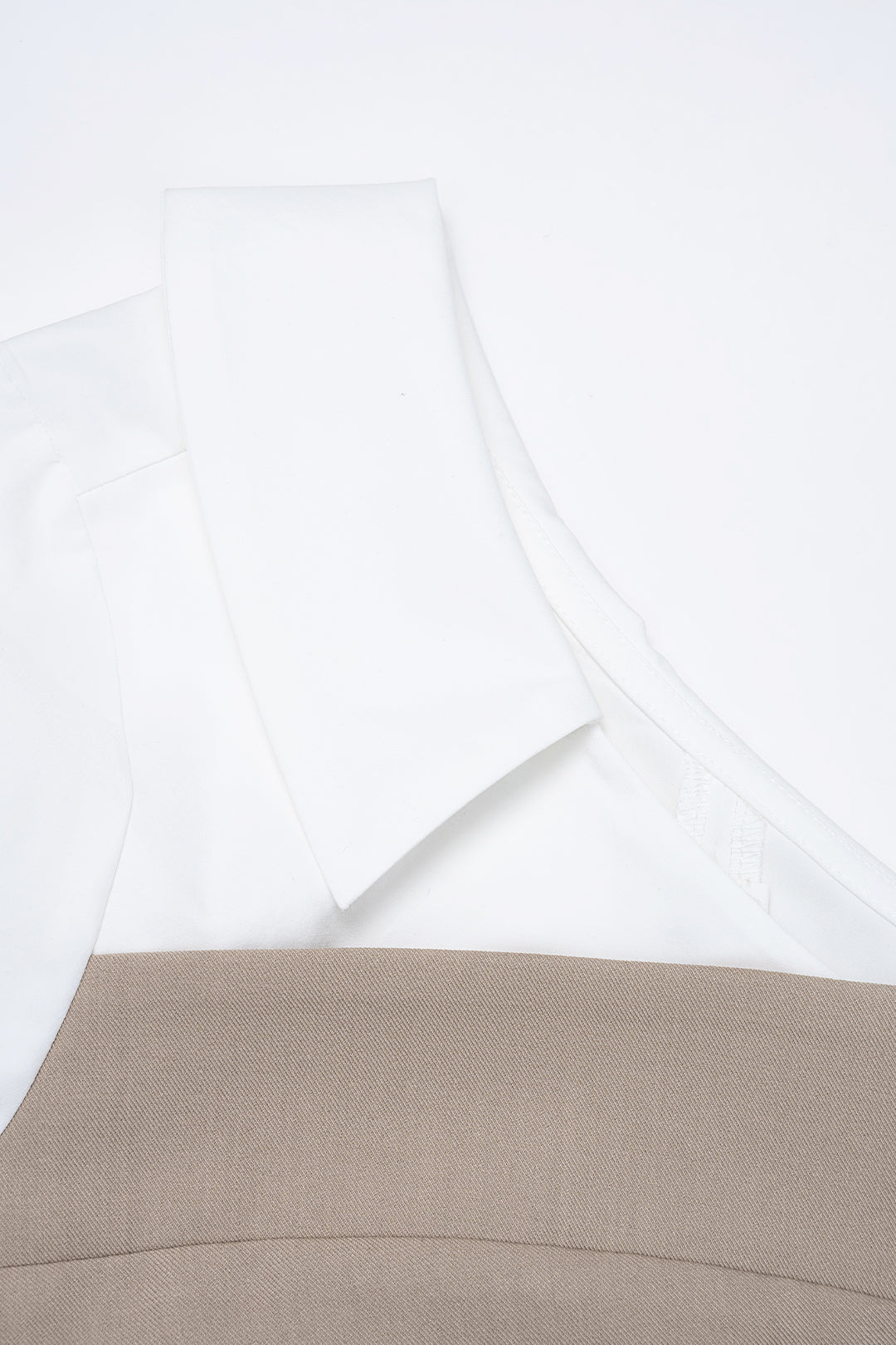 Detail of the white fold-over collar and beige corset neckline on the Milan Beige Top