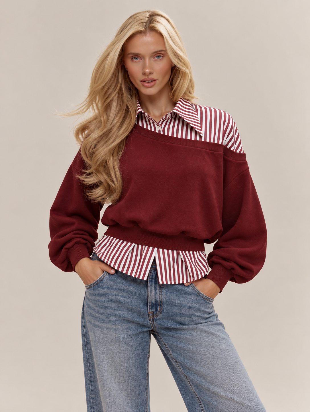 Model wearing the Boston layered sweatshirt in burgundy with a striped collar and wide-leg jeans
