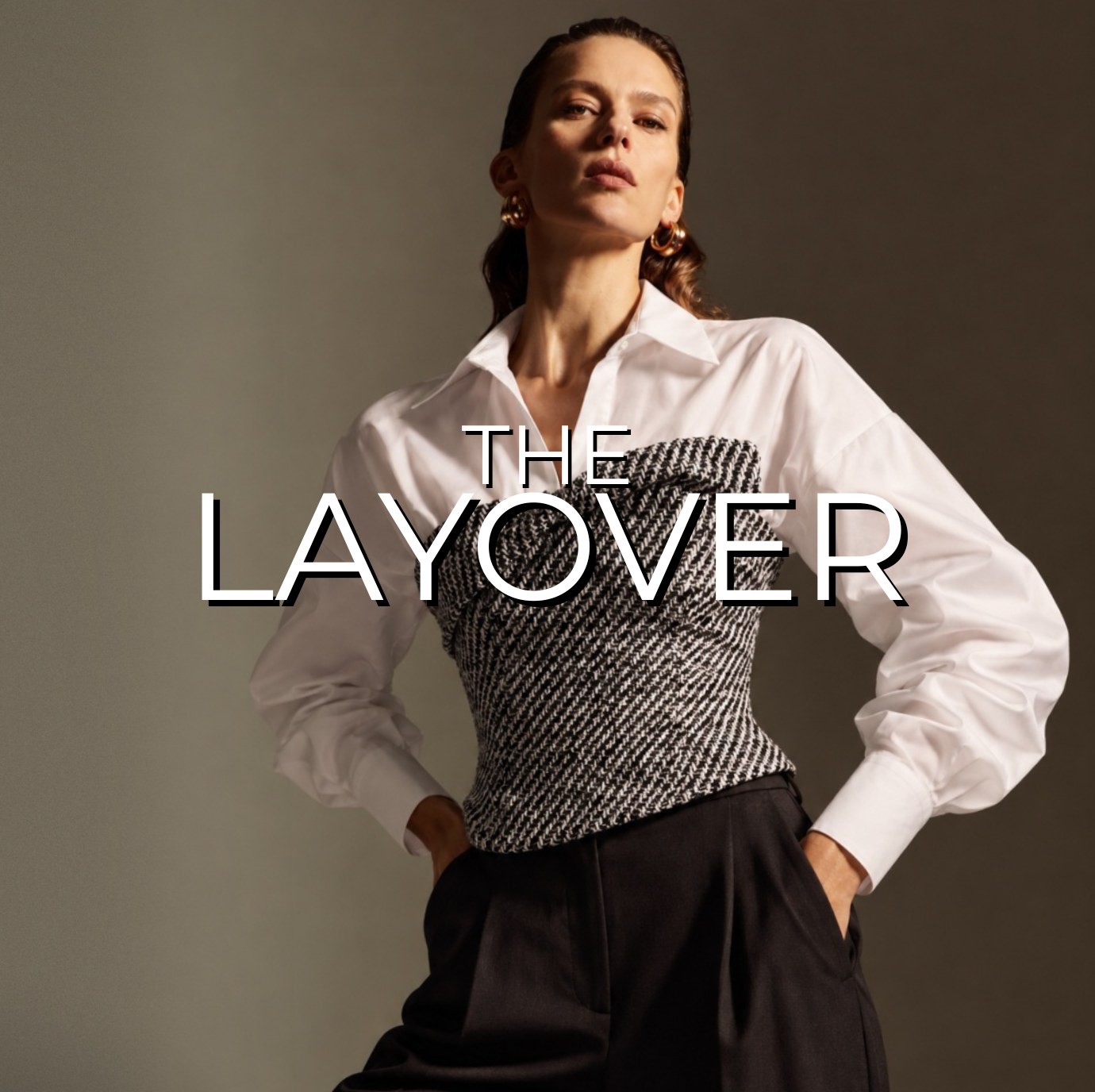 The Layover – Fall Collection The Layover, Revelle's debut fall collection: model in a white shirt with a tweed corset and black trousers